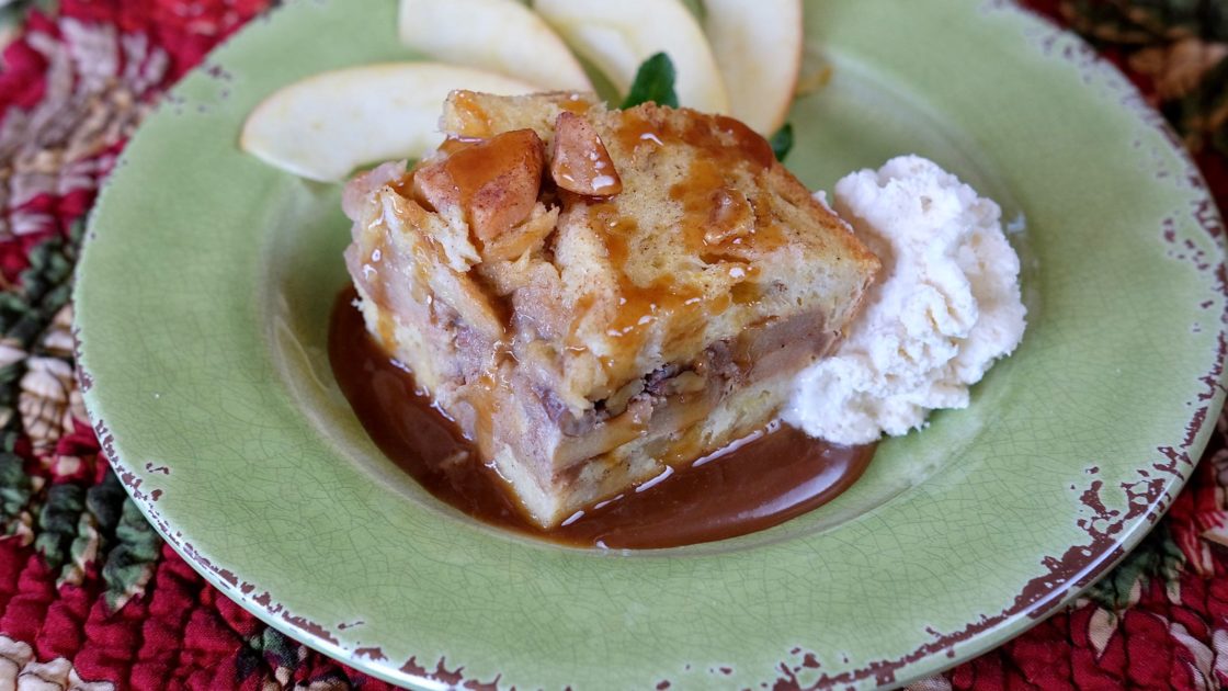 Apple Cinnamon Strata garnished with apple cider caramel sauce, whipped cream and fresh apple slices
