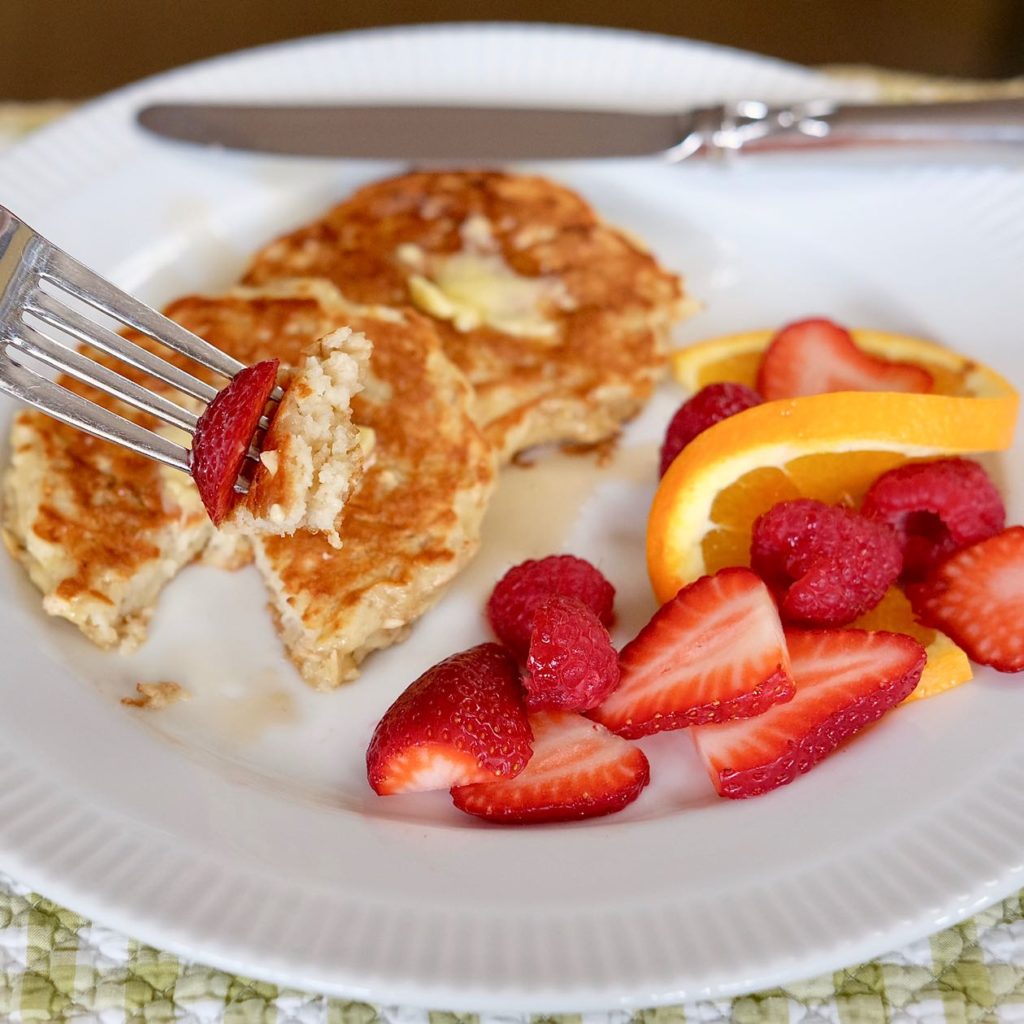 Lemon Breeze Apple Pancakes with fresh strawberries, raspberries and orange slices.