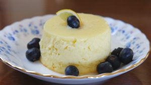Lemon Buttermilk Pudding Cake garnished with blueberries and lemon slice