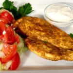 Chicken Shawarma with Tomato Cucumber Salad and Yogurt Sauce on white plate