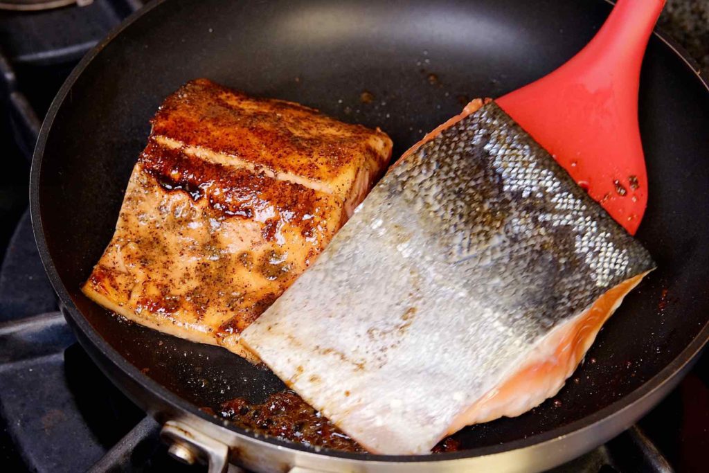 Pan Seared Barbecue Salmon searing in non-stick skillet.