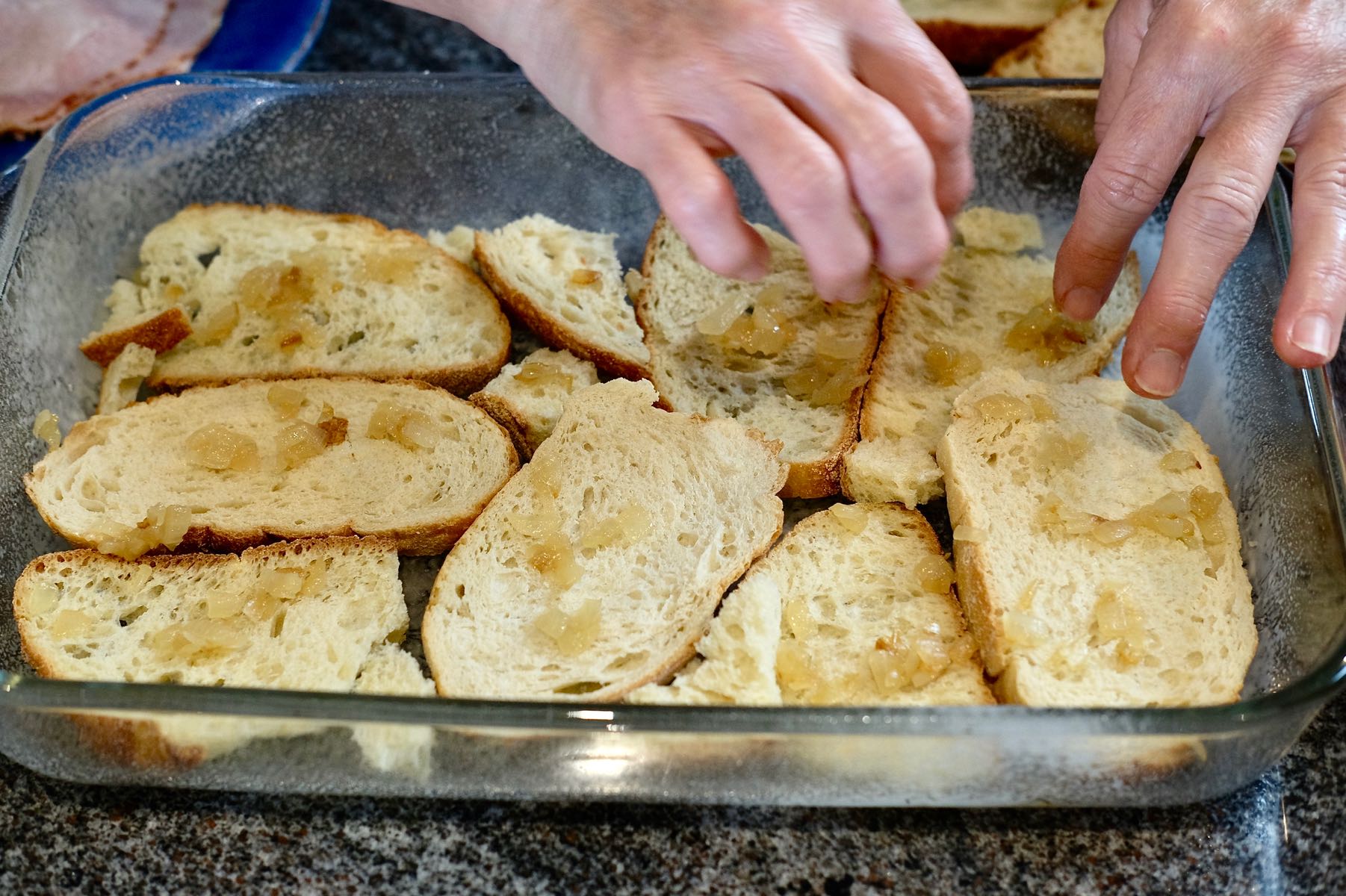 Layering the bread with caramelized onion.