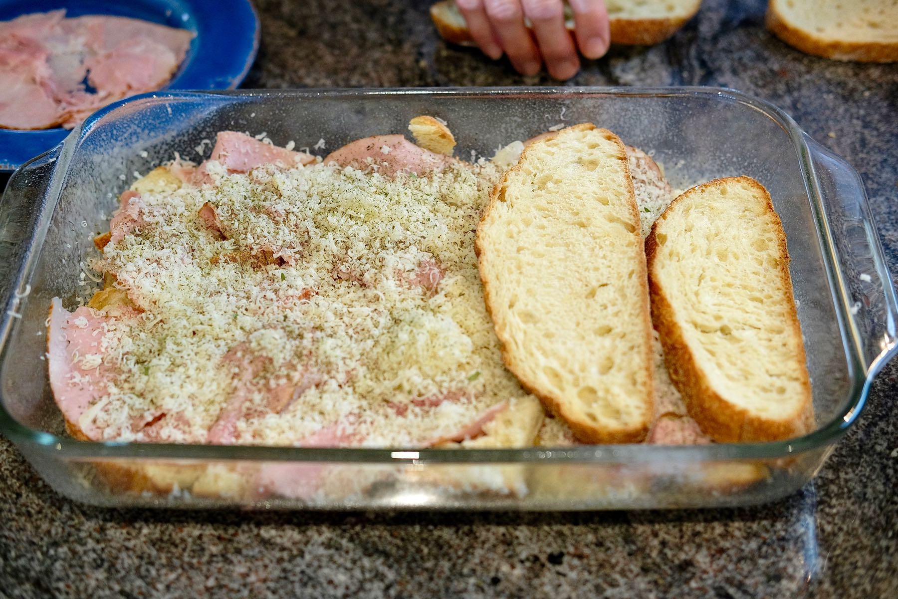 Assembly of the second layer of bread in glass baking dish.
