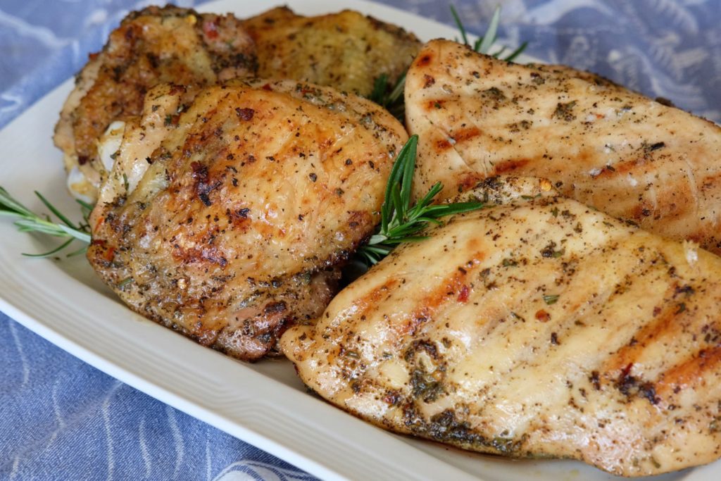 Grilled Mediterranean Chicken on white plate and blue linen