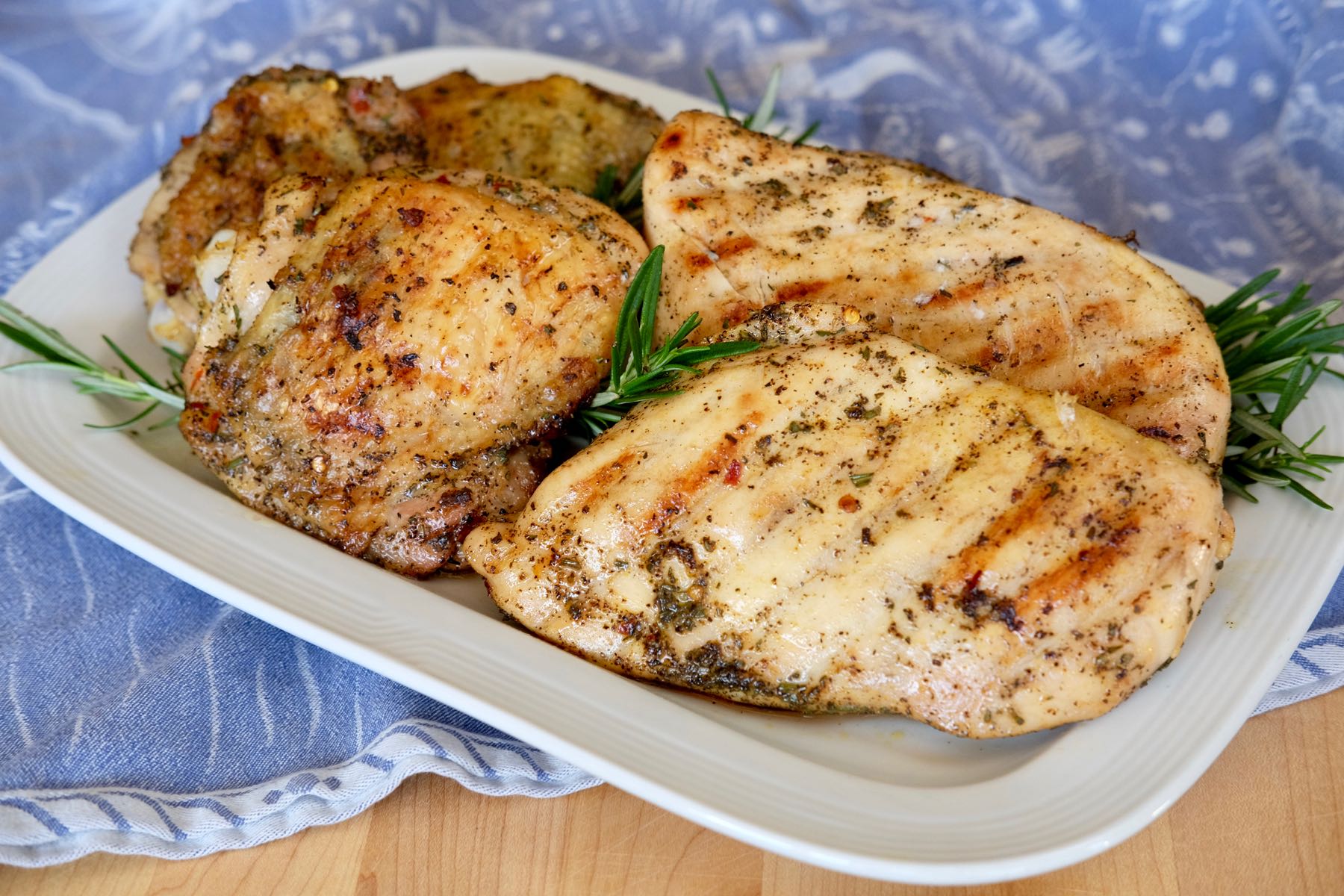 Grilled Mediterranean Chicken on white dish and blue linen