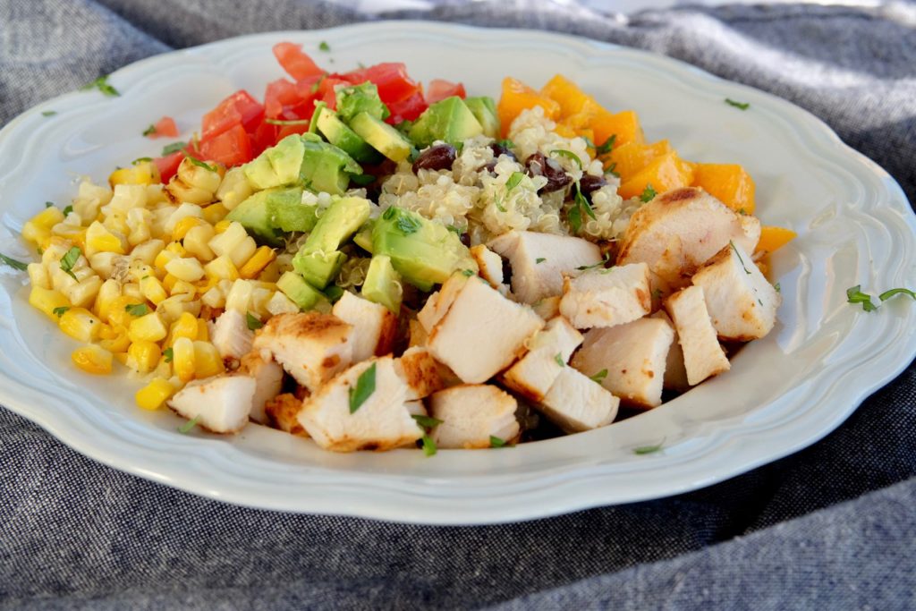 Quinoa and Black Bean Salad with chopped chicken, vegetables and mango