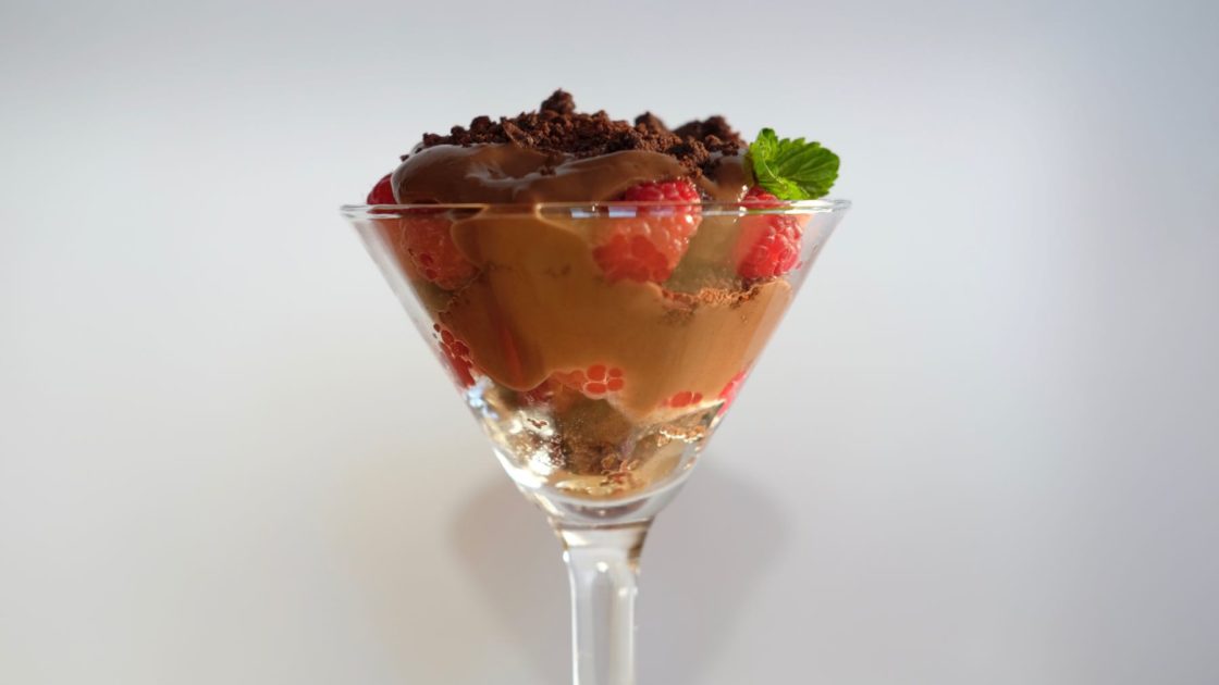 Chocolate Raspberry Parfait in a martini glass with Chocolate Sand and Fresh Mint