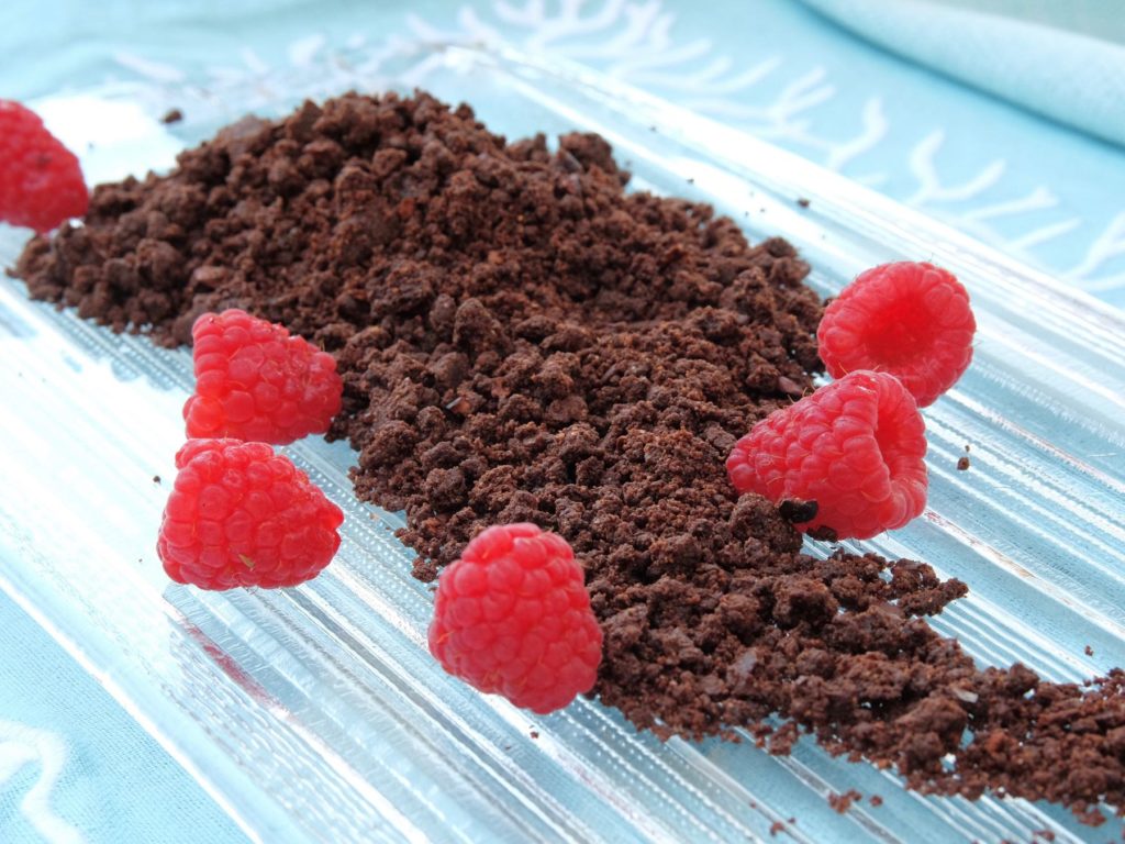 Chocolate Sand on glass dish with raspberries