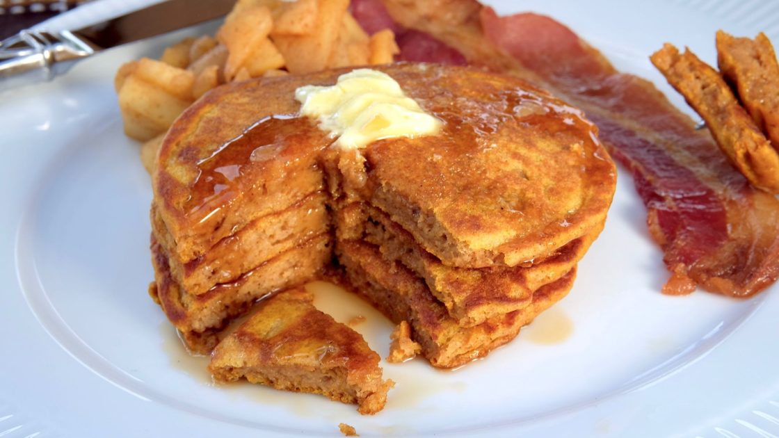 Fluffy Pumpkin Spice Pancakes served with Sauteed Cinnamon Apples , bacon and maple syrup