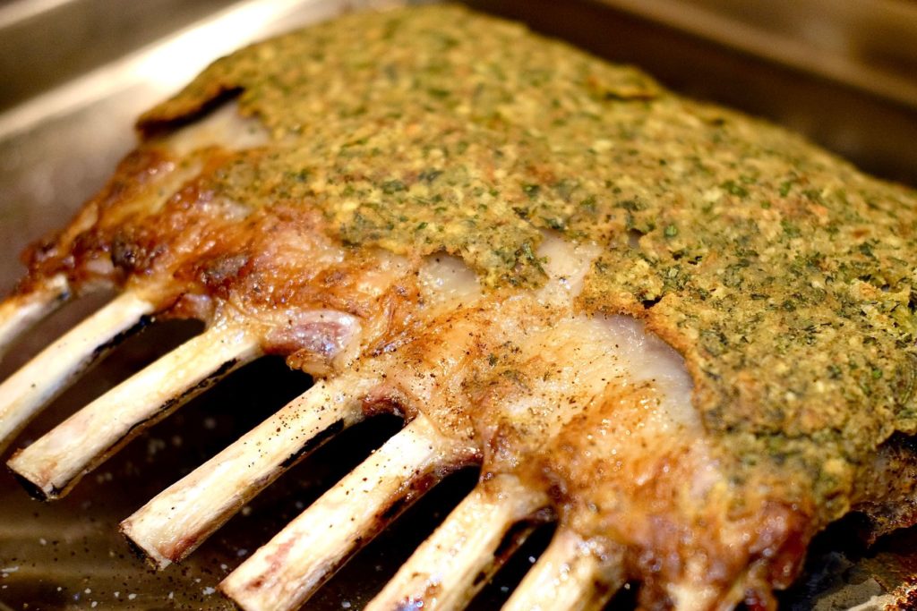 Herb-Crusted Rack of Lamb on baking tray resting after roast.