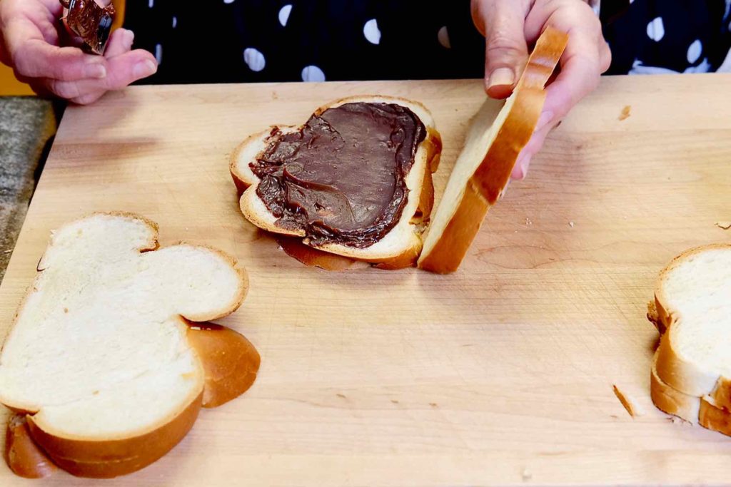 Nutella and Mascarpone French Toast being assembled with slices of bread.