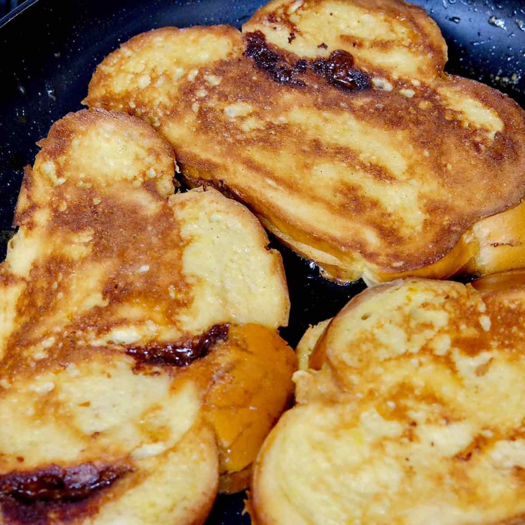 Nutella and Mascarpone Stuffed French Toast sauteing in pan