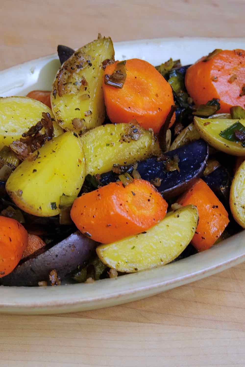 Colorful Roasted Baby Potatoes with Carrots in serving bowl.