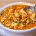 Tuscan Bean Soup in white bowl with a spoonful of soup