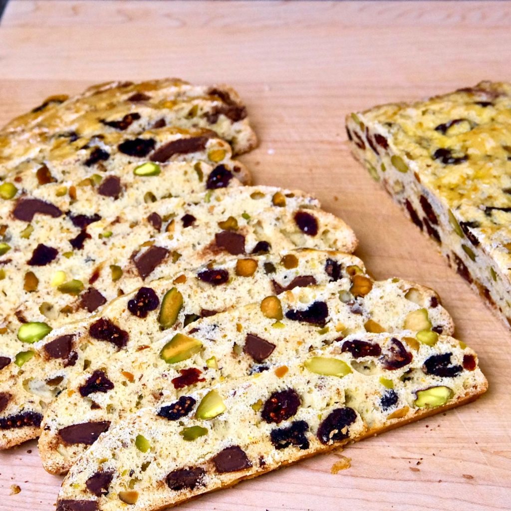 Chocolate Cranberry Holiday Biscotti on maple cutting board.