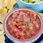 Roasted Salsa in a blue & white earthen bowl surrounded by tortilla chips