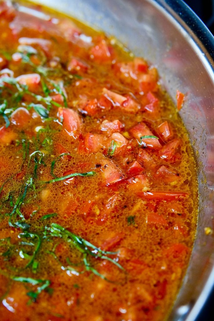Stainless steel pan of simmering Fresh Tomato Sauce