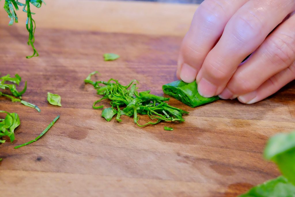 Image gallery showing steps to cutting basil chiffonade.