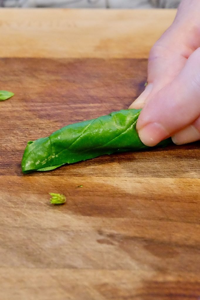 Image gallery depicting steps to cut basil chiffonade.