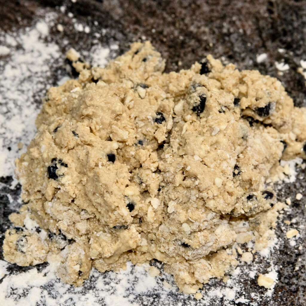 Mixed scone dough turned out onto a lightly floured granite surface.