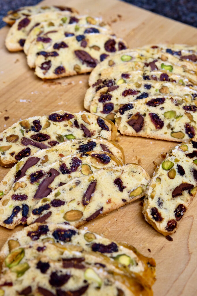 Chocolate Orange Biscotti slices fanned across a maple cutting board.