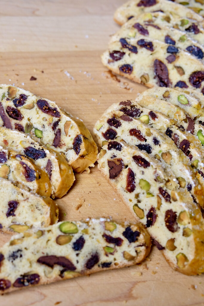 Chocolate Orange Biscotti slices fanned out and displayed on a maple cutting board.