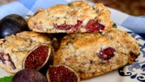 Fresh Fig Scones set on a blue and white plate with whole fresh figs in the foreground.